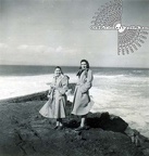 Coated Women On A Rocky Seaside